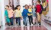 Multiracial-group-of-preschoolers-running-down-hallway-TRIMMED-2650x1569