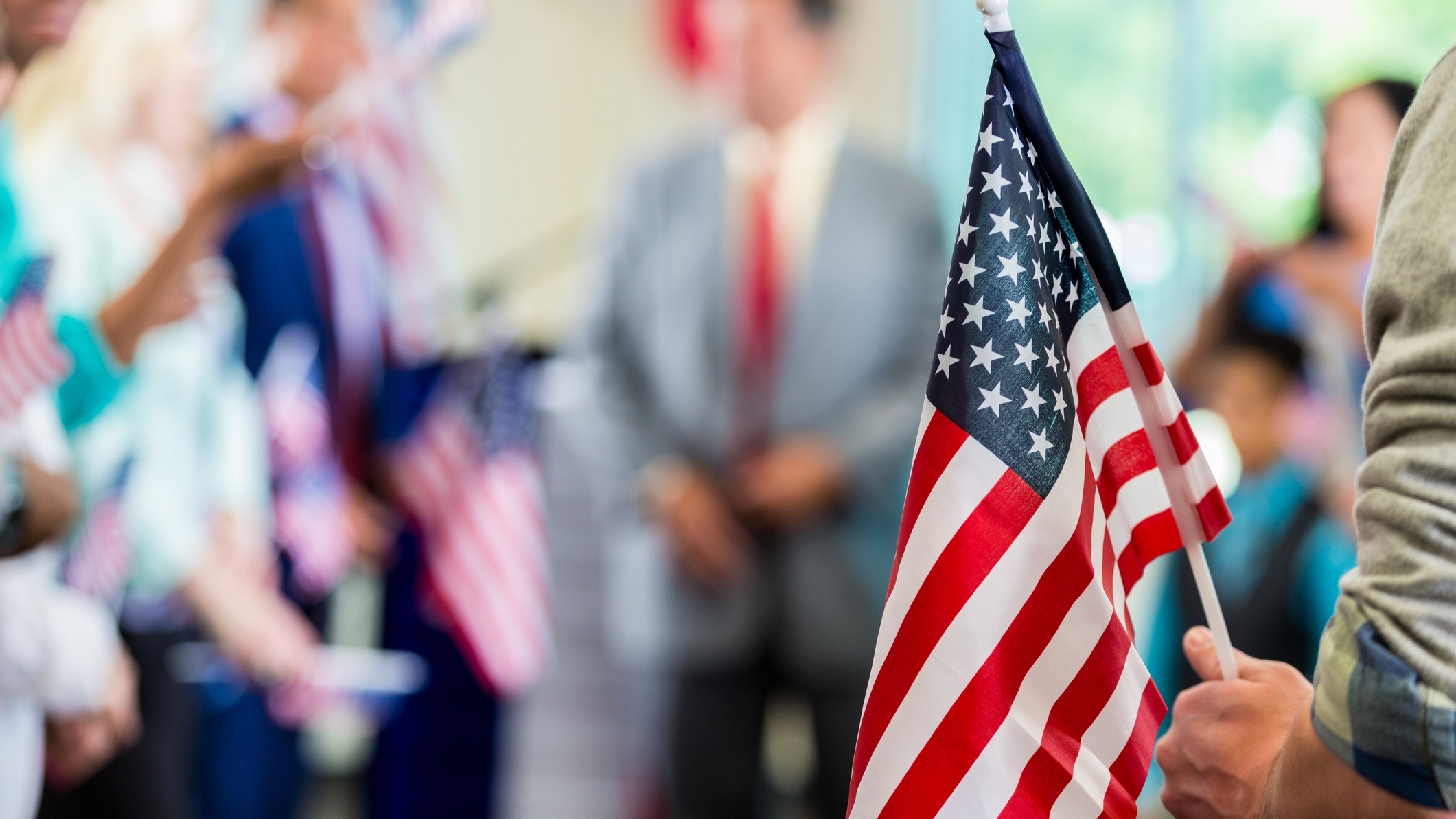 Supporters waving American flags at political campaign rally