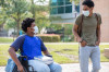 One disabled college student walking with friend