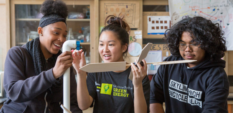 Two high school girls and one high school boy in science lab