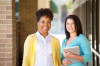 Business women standing outside an office building.