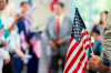 Supporters waving American flags at political campaign rally