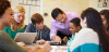 High School Students With Teacher In Class Using Laptops