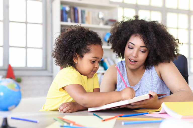 Mom,_daughter_school_at_home_iStock-819770674